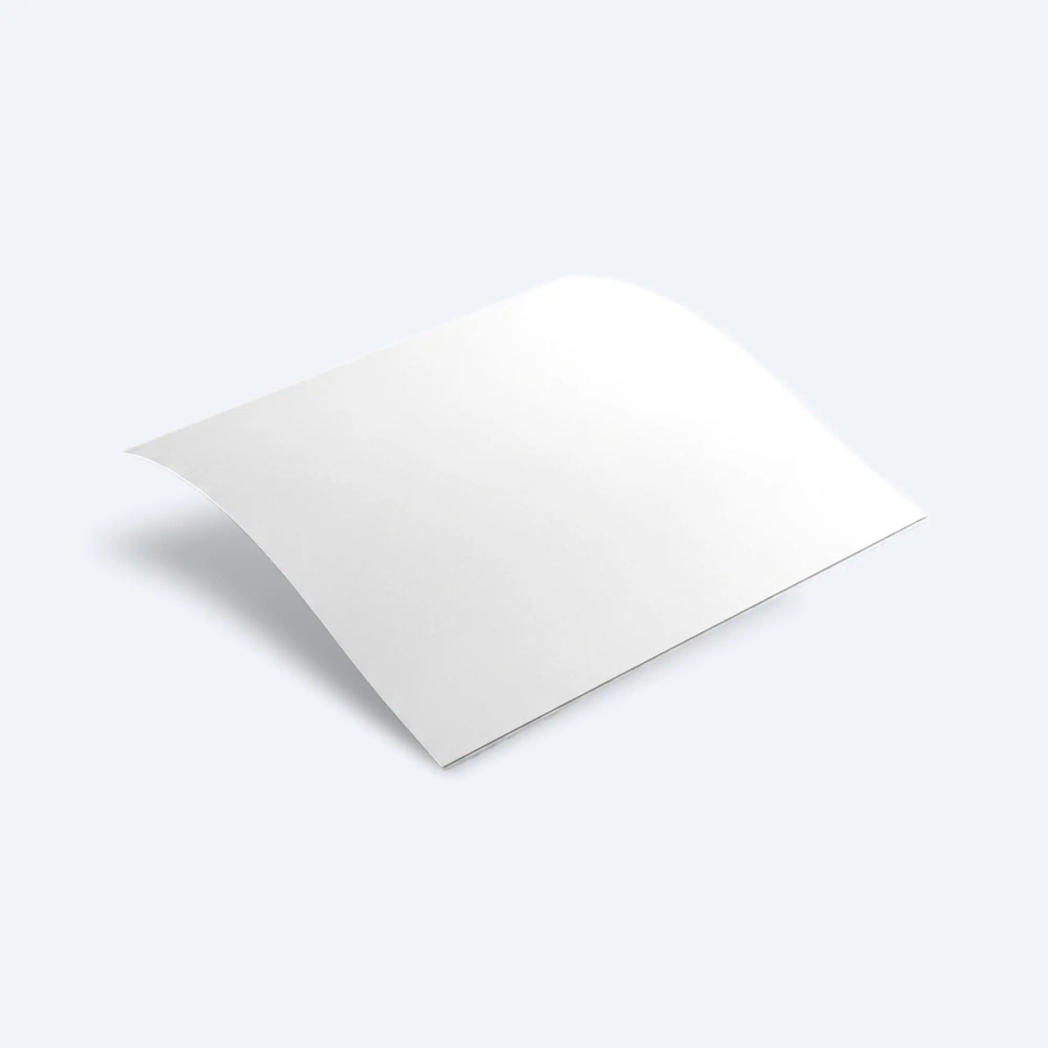 Single blank newsprint sheet slightly curved in mid‑air, highlighting lightweight, flexible texture.