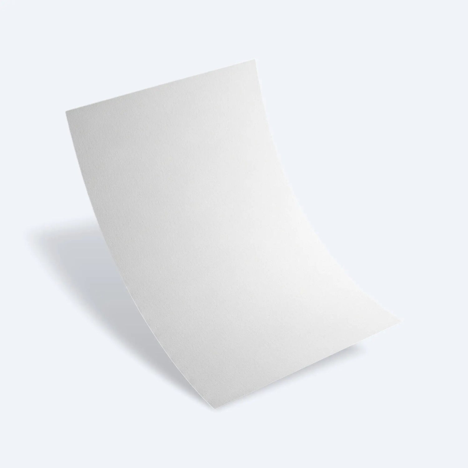 Curved newsprint sheet lying on a flat surface, illustrating easy folding for protective wrapping.