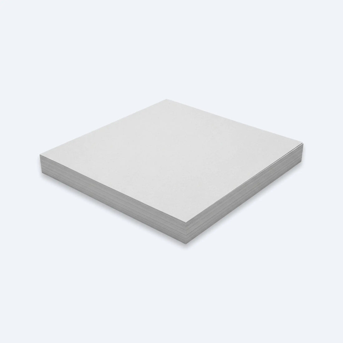 Low stack of unprinted newsprint paper sheets neatly squared for bulk packaging use.
