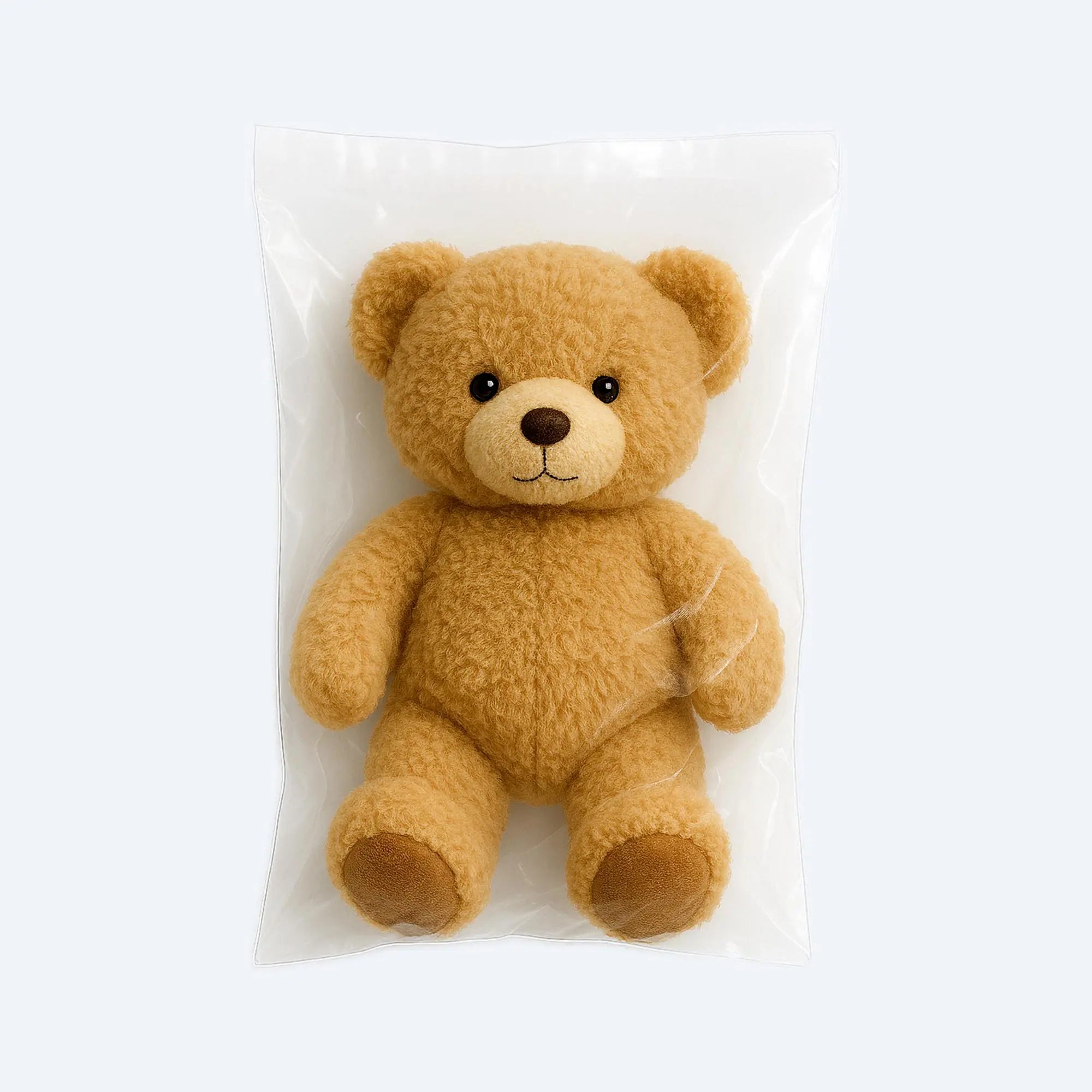 Brown teddy bear showcased inside a clear PE flat open‑mouth bag demonstrating size and product visibility.