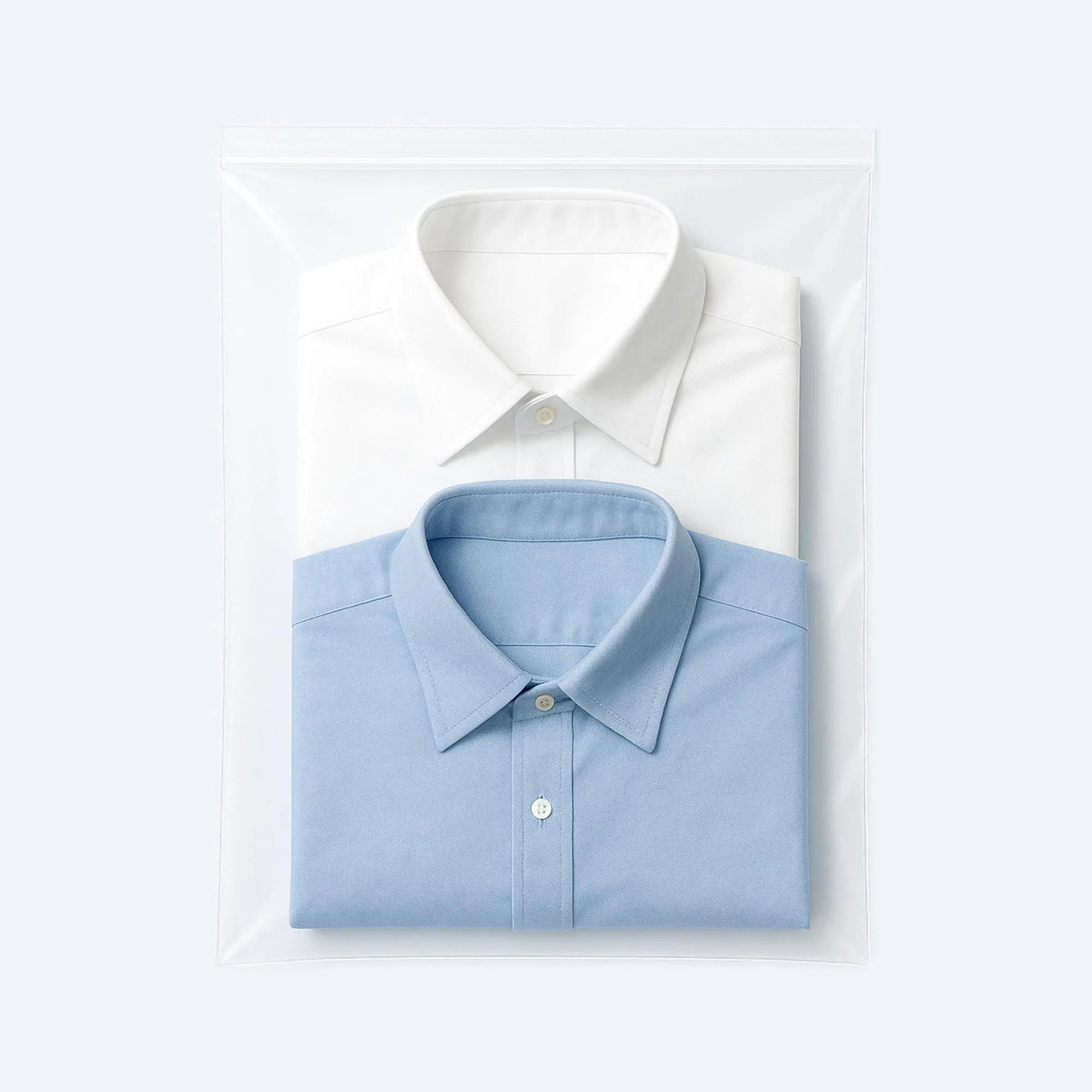 Two folded dress shirts packed inside a large resealable clear ziplock bag, ideal for dust‑free, moisture‑safe garment storage.