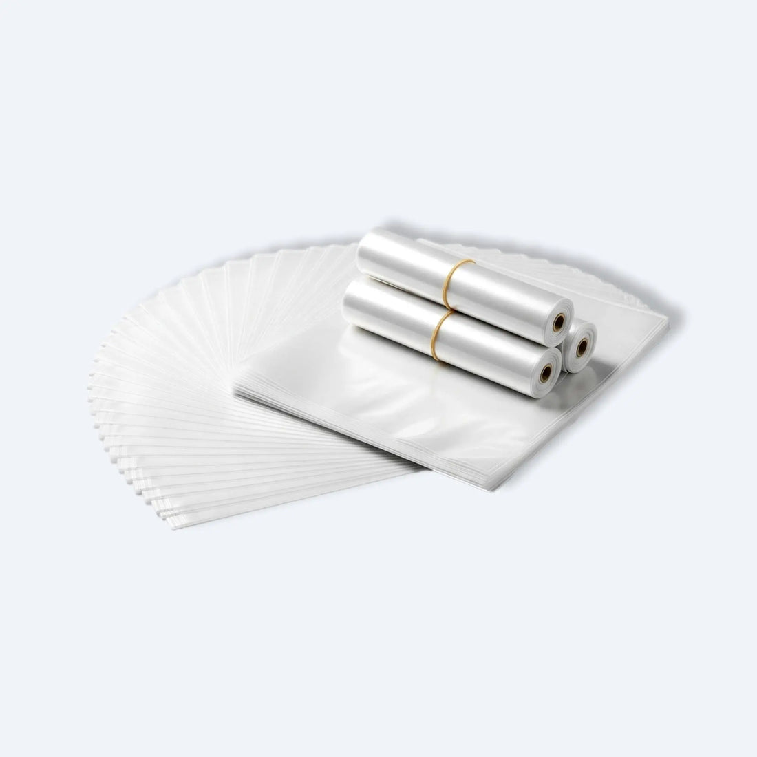 Bundle of clear PE flat open‑mouth bags stacked with three bag rolls, ideal for packaging clothing or crafts