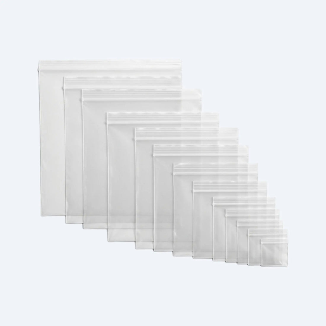 Assorted sizes of resealable clear ziplock bags arranged in a fan layout, showing the full range for versatile storage.